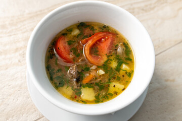 Hot meat soup with tomatoes and potatoes