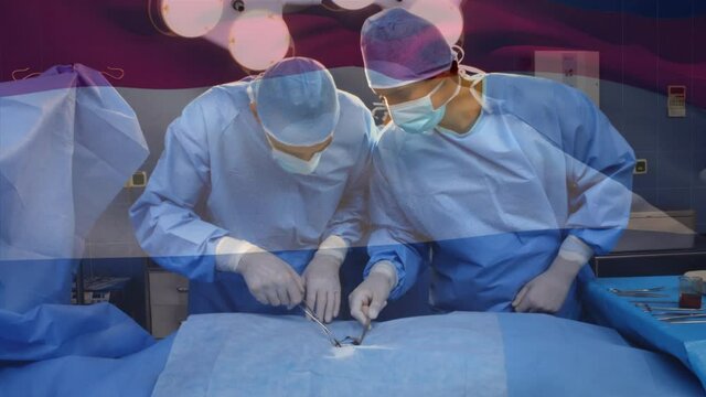 Animation of flag of netherlands waving over surgeons in operating theatre