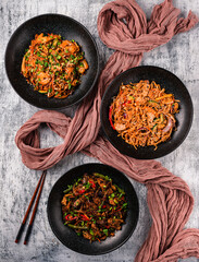 Asian food table with various kind of chinese noodles with chicken, pork, beef and others