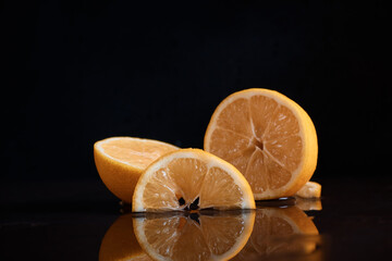 Slices of lemon citrus on the table juicy cut off reflection in the water juice blurred background