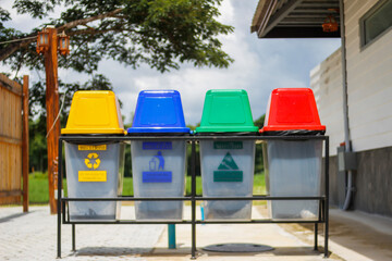 Fototapeta na wymiar The multi-colored bins are arranged next to each other as bins for sorting waste for recycling and have universal symbols for all tourists to understand in order to separate the waste before disposal.