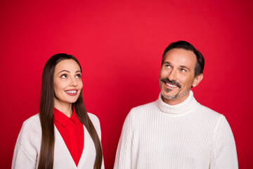 Photo of happy curious cheerful mature man and woman look empty space idea plan isolated on red color background