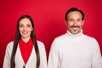 Photo of cheerful mature man and woman married couple christmas good mood isolated on red color background
