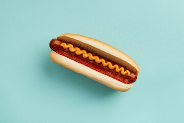 Classic hot dog with wurst, ketchup and mustard on blue background. Menu for restaurant
