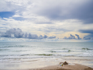 A pile of sand on the beach by the sea after the evening rain.