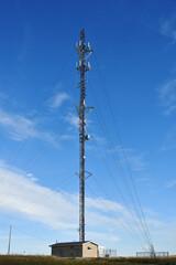Obraz premium An image of a tall communications tower against a bright blue sky. 