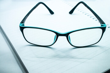 Blue glasses and notebooks.