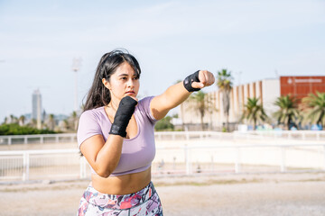 athlete woman making the gesture of strength with her arm