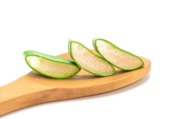 Sliced â€‹â€‹fresh green aloe leaves in wooden spoon isolated on white background. Skincare concept, health and beauty spa..