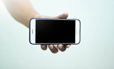 A full white mobile phone is in the hands of the people.