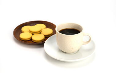Coffee and stuffed cookies in a separate plate on white background..
