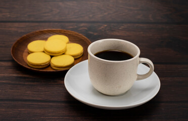 Coffee and cookies stuffed in separate plates on dark wood floors.