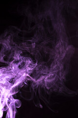 The movement of pink smoke takes place on a fierce black background, fearing an abstraction on a black background.