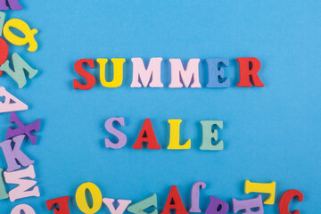 Summer sale word on blue background composed from colorful abc alphabet block wooden letters, copy space for ad text. Learning english concept.