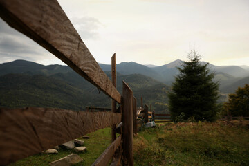 Fototapeta premium Beautiful view of mountain countryside with wooden fence