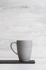 Grey coffee mug on a white rustic background