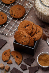 Freshly baked homemade vegan oatmeal cookies with chocolate chips and spices. Delicious healthy biscuits for tea. Selective focus