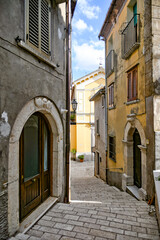 Fototapeta na wymiar A narrow street of Cusano Mutri, a medieval town of Benevento province, Italy.