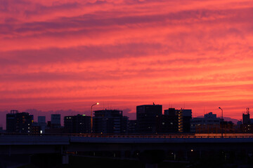 cityscape with bypass bridge under red sky
