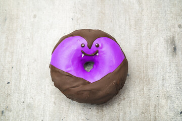 Funny little monster donut for halloween bright colors with little eyes