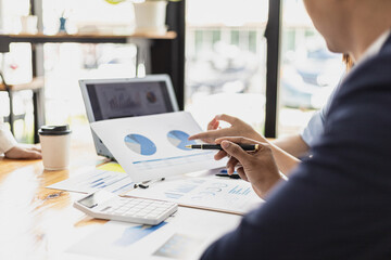 Executives and managers are meeting in a conference room, on the table there are some documents about the company's finances, managers are discussing financial information with the management.
