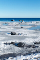 Icy boulders at the shore. Baltic sea, winter time.