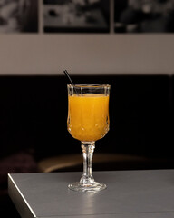 glass of orange juice with a straw