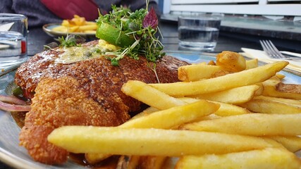 Closeup of schnitzel and french fries