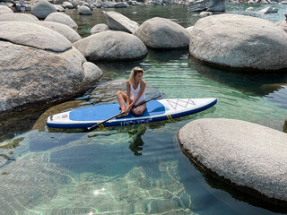 Beautiful yang lady relaxes on the paddle board 