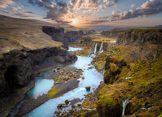 Fototapeta na wymiar Beautiful sunset and landscape of Sigoldugljufur canyon with many small waterfalls and the blue river in Highlands of Iceland