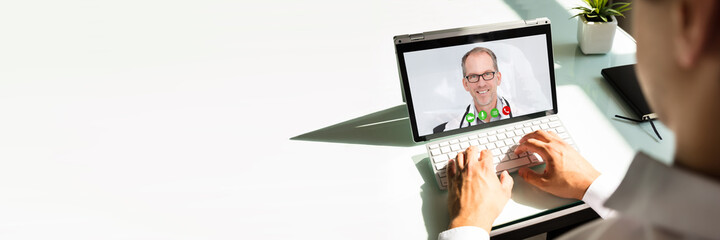 Fototapeta na wymiar Businessman videoconferencing with doctor on laptop