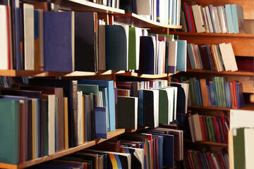 Collection of different books on shelves in library