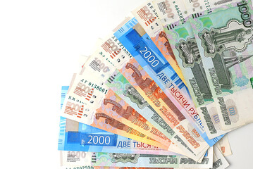 Russian rubles are fanned out on a white background. Currency exchange. Financial crisis, ruble devaluation concept. Selective focus. Top view, flat lay.