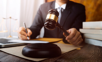 Business and lawyers discussing contract papers with brass scale on desk in office. Law, legal services, advice, justice and law concept picture with film grain effect