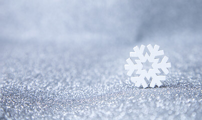 A white snowflake on a silver background. Winter background, Christmas background