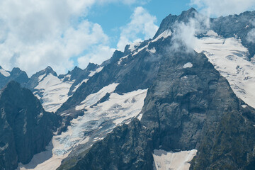 Landscape, mountain panorama, alpine meadows and mountain peaks in ice