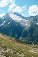 Fototapeta na wymiar Landscape, mountain panorama, alpine meadows and mountain peaks in ice
