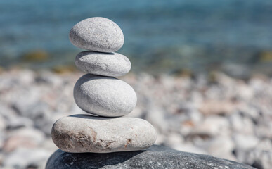 Zen balance stones, smooth pebbles pyramid stacked on the beach