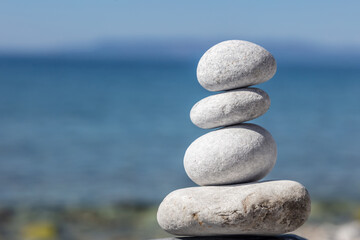 Fototapeta na wymiar Zen balance stones, smooth pebbles pyramid stacked on the seashore