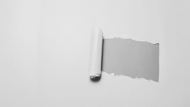 Stop motion photography concept. Diagonally torn paper in black and white.