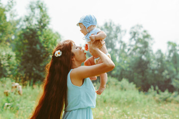 mother raises the child in her arms