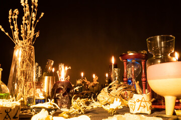 Witchcraft still life with burning candles selective focus on skull. Esoteric gothic and occult...