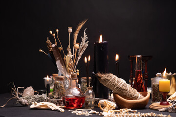 Witchcraft table set, selective focus. Alchemy and esoteric symbol items for magic cult. Spiritual occultism and magic chemistry inspired by mysticism. Witch and warlock magician concept. Halloween.
