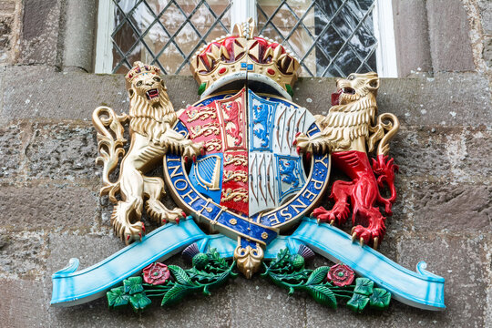Glamis, Scotland, United Kingdom – September 11, 2017. The coat of arms of the late Queen Elizabeth the Queen Mother, on the gates at the entrance of Glamis Castle in Scotland.