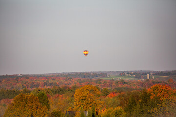 Hot air balloon flying over Wisconsin farmland in late September