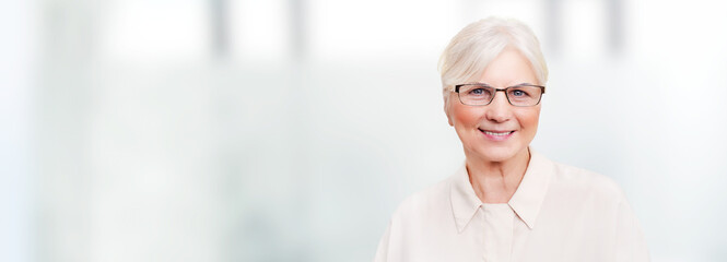 Woman with eyeglasses, elderly person smiling