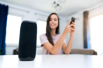 Woman using smart speaker, home assistant