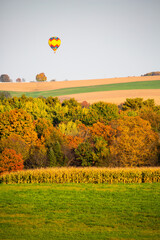 Hot air balloon flying over Wisconsin farmland in late September - obrazy, fototapety, plakaty