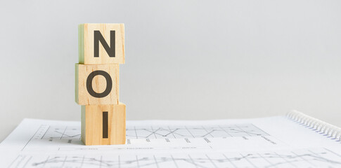 the word NOI structured query language, lined with wooden blocks