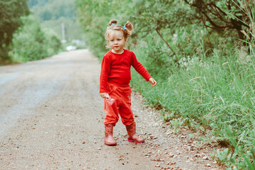 a child is walking along a country road